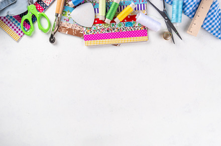Colorful fabric pieces with sewing tools, an Industrial Photo by Rimma