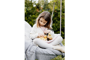 Girl sitting on swing with baby, an Animal Photo by HalfPoint
