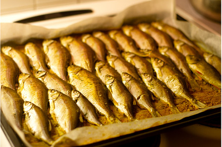 baked fish lies on a baking tray