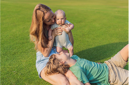 Mother, older son, and newborn baby