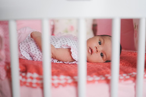 cute newborn baby lying in bed