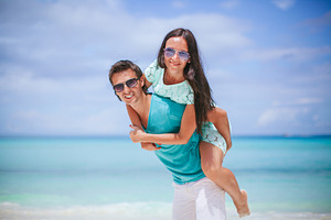 Young couple on white beach during s