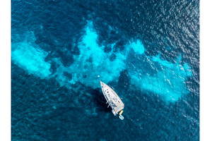 Aerial view of a yacht in the, a Nature Photo by den-belitsky