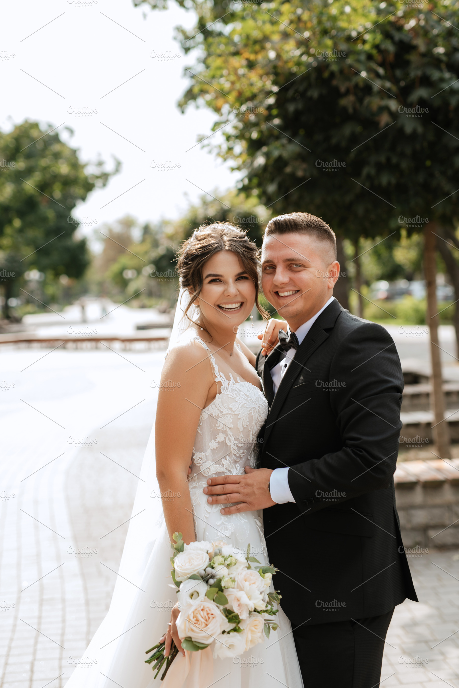 the groom in a brown suit and the bride in a white dress, a Person Photo by Weddings, People, Travel
