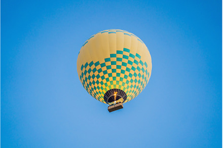 Beautiful hot air balloons over blue, a Transportation Photo by Elizaveta Galitskaya