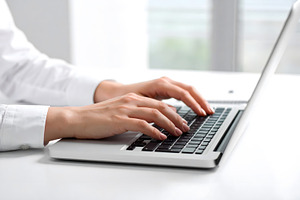 Businesswoman working on laptop at clean bright modern desk, a Business Photo by GoodGoods