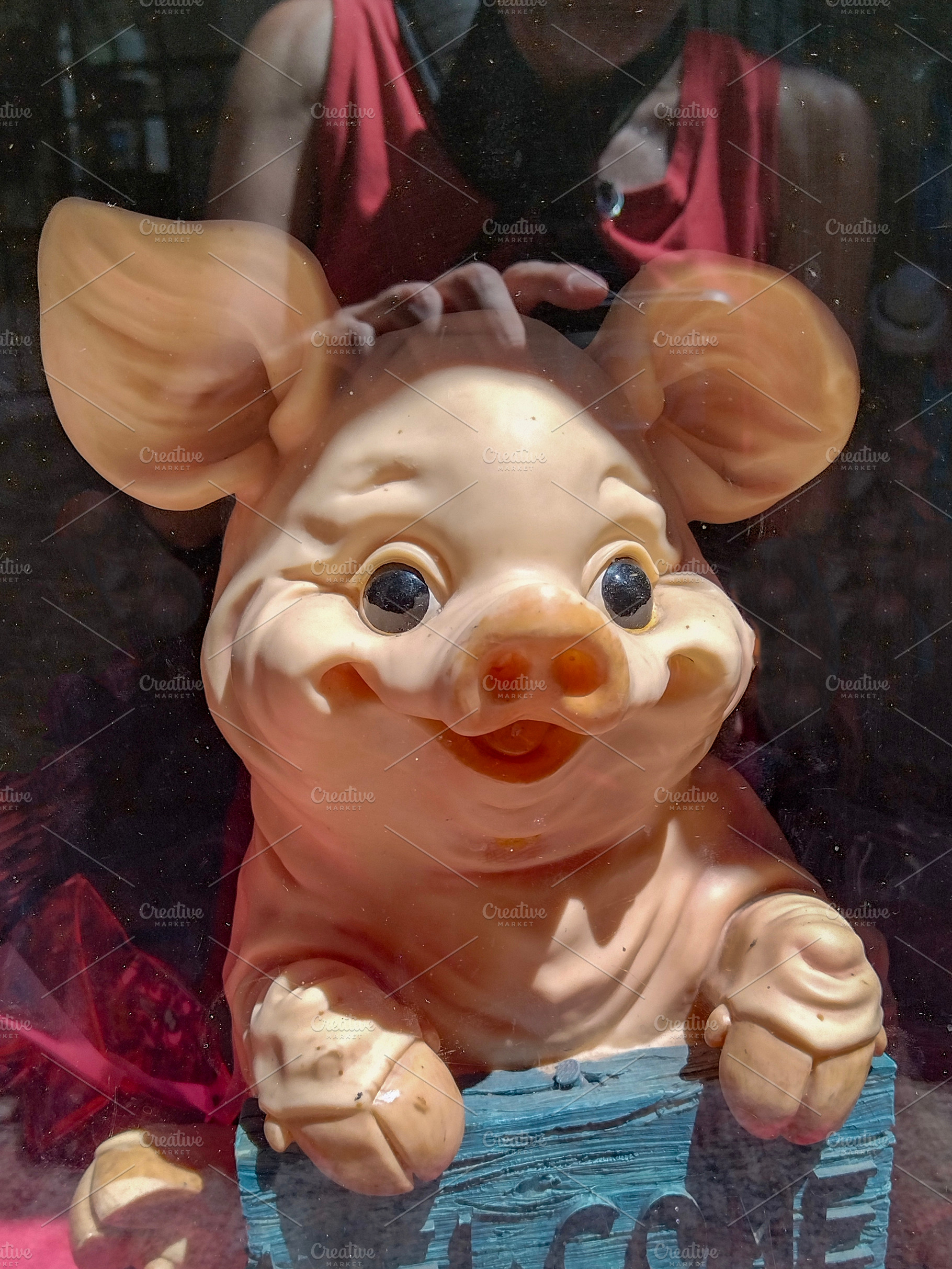 Whimsical pig statue in window, an Animal Photo by DanFLCreativo