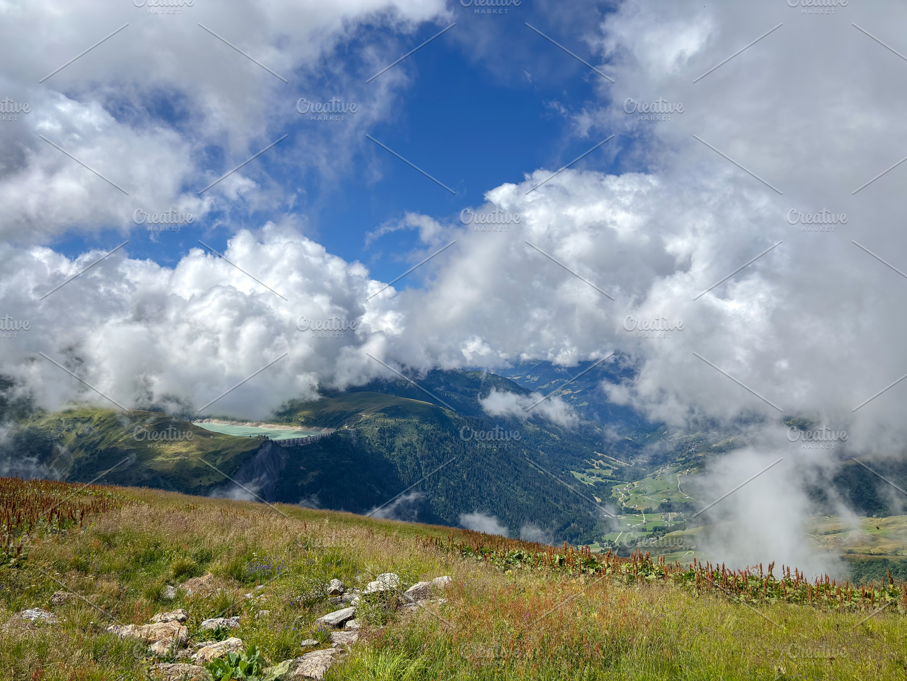 Cloudy alpine valley view from mountain meadow in Les Contamines, a Nature Photo by GoodGoods