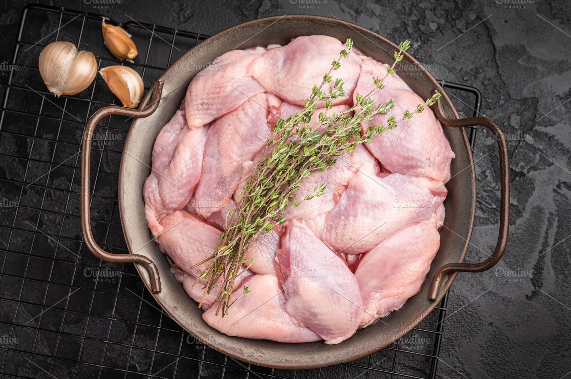 Raw quail breast fillets with thyme and garlic in a metal pan on, a Food & Drink Photo by composter-box@mail.ru