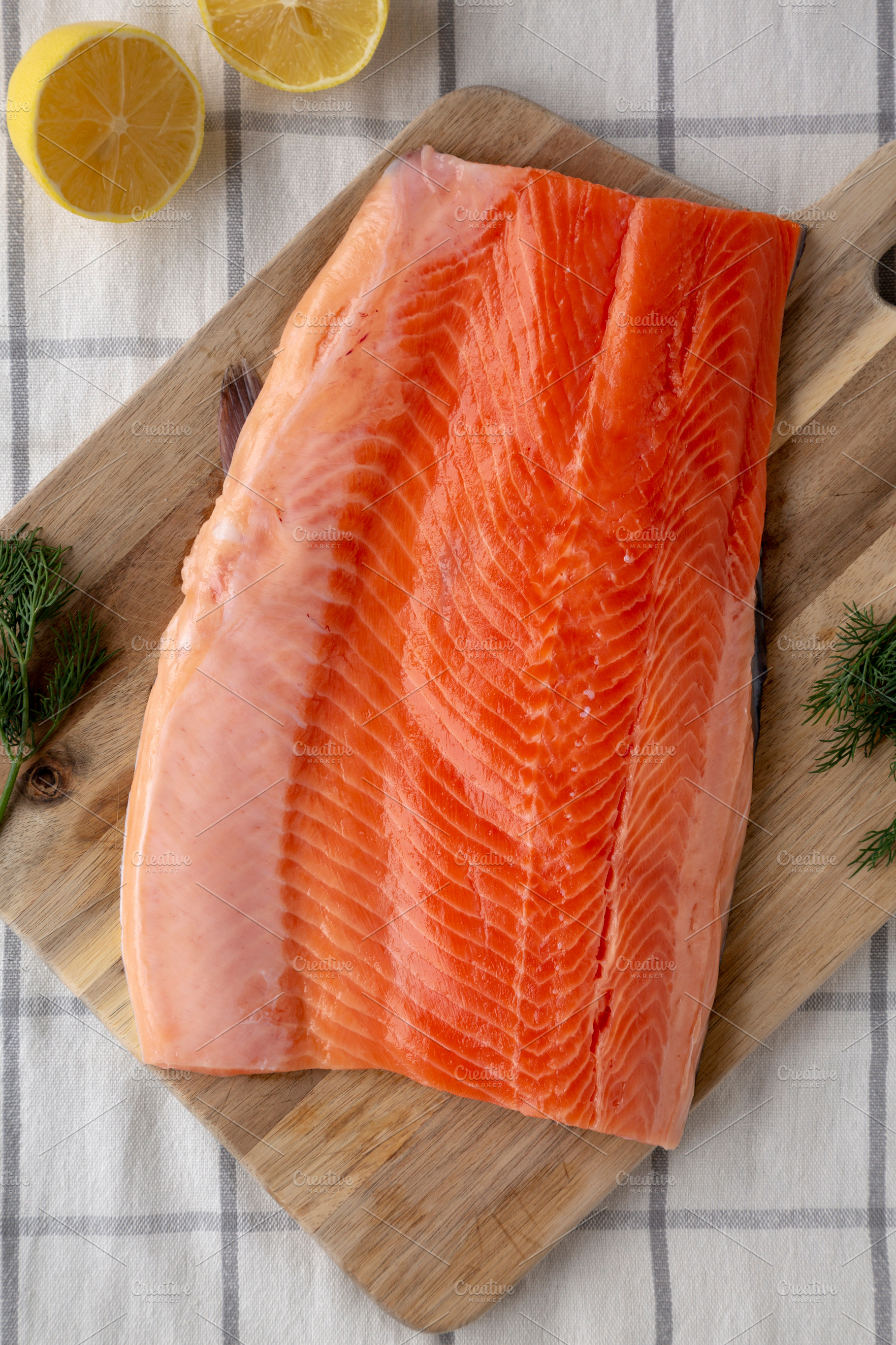 Organic Raw Salmon Fillet on a wooden board, top view. Flat lay,, a Food & Drink Photo by LiudmylaChuhunova