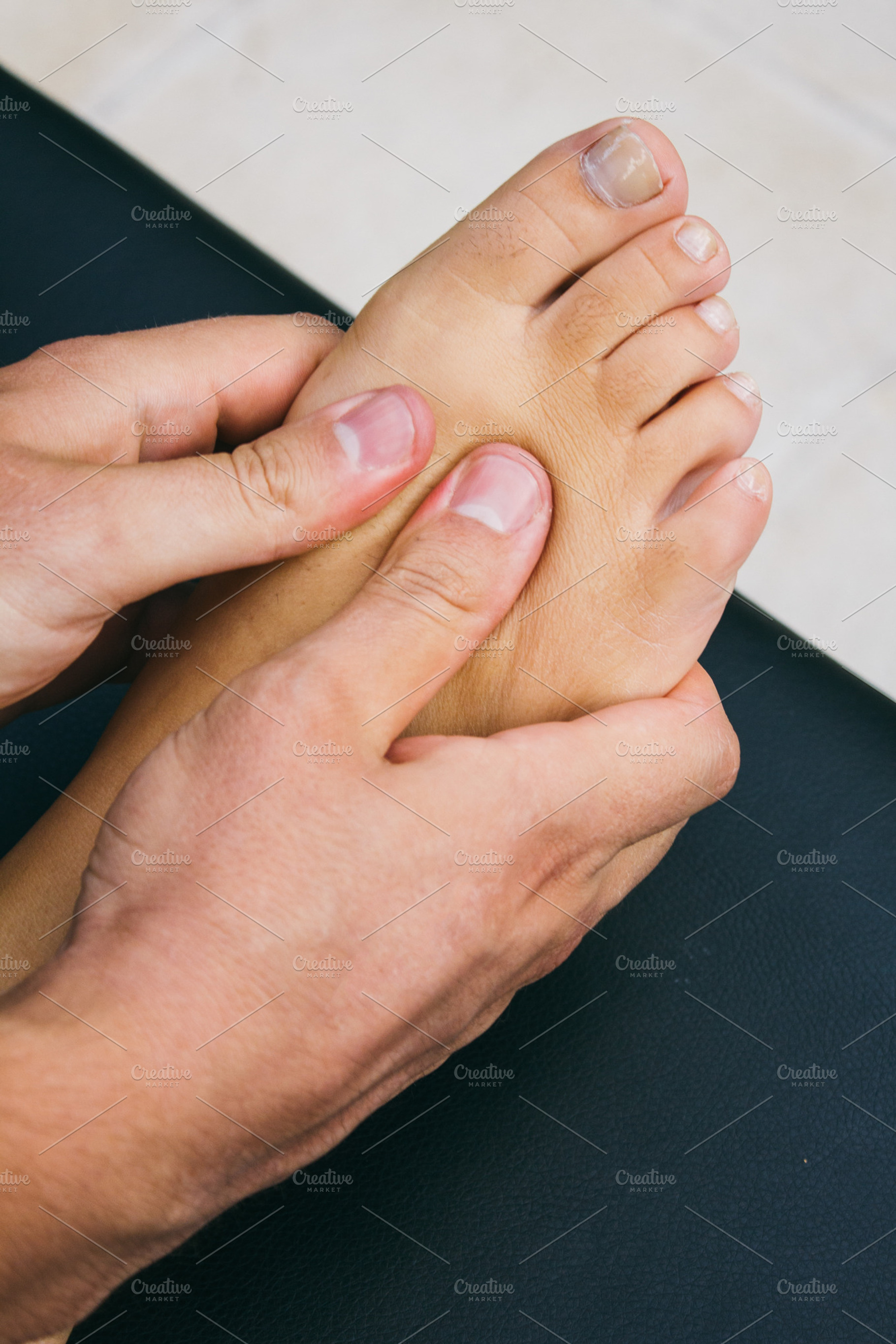 Physiotherapist massaging a foot, a Health & Medical Photo by Am.Benitez Estudio