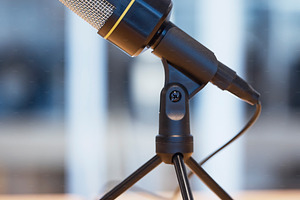 Music, podcast and radio with microphone in office for live streaming, recording and interview. Technology, network and news with equipment on desk in studio for communication, media and audio, a Photo by Peopleimages.com