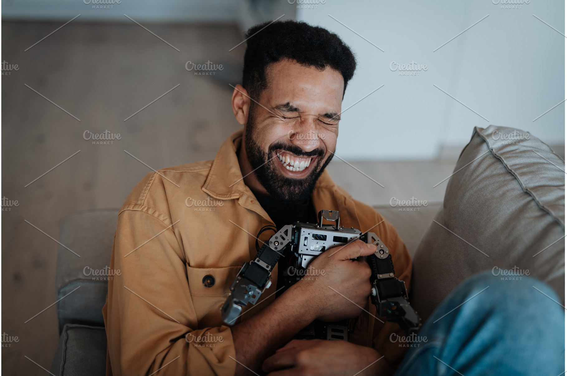 Handsome man hugging small robot, a Technology Photo by HalfPoint