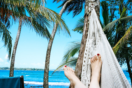 Woman relaxing in Hammock on beach, a Person Photo by Annakaroline