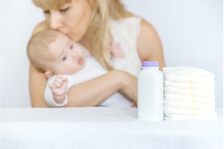 mother changes baby's diaper on a, a Person Photo by yanadjana
