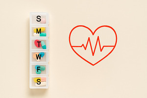 Heart health flatlay with pill organ, a Photo by Dvoevnore photos