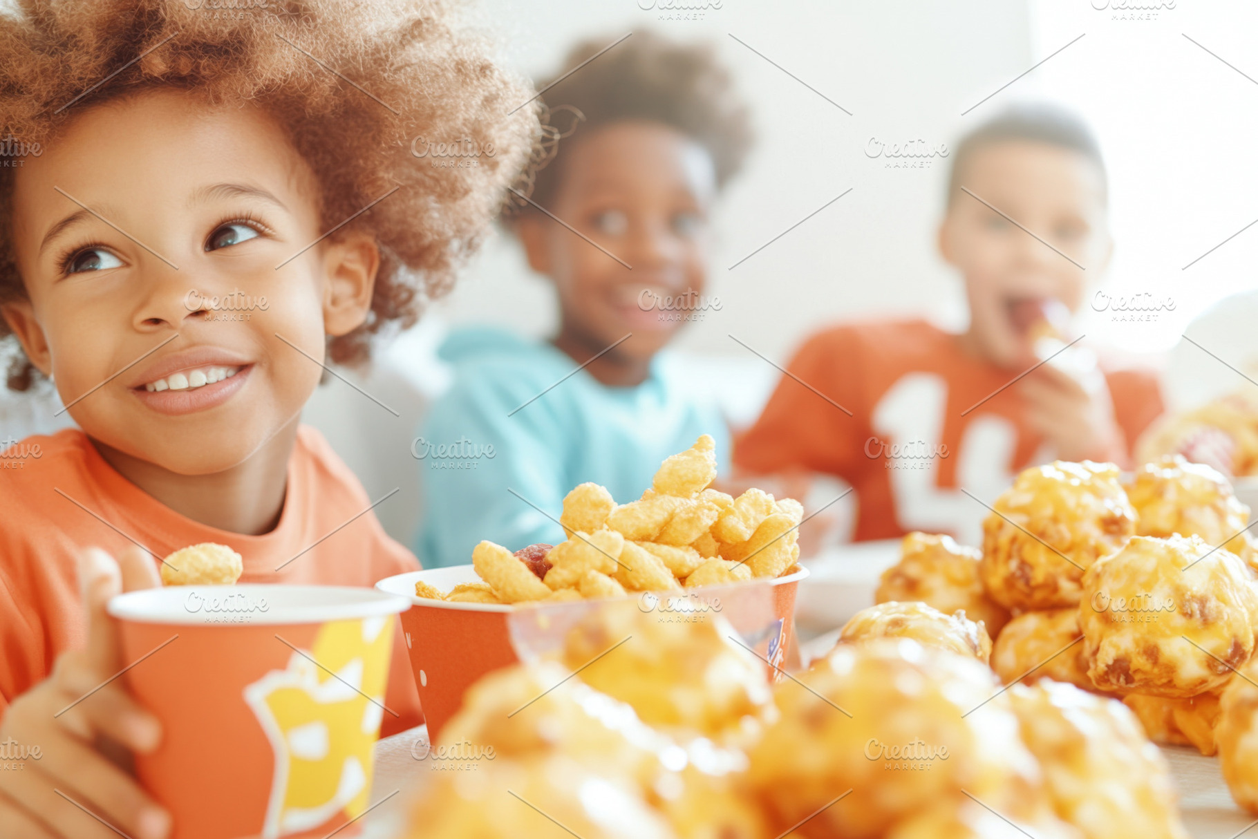Mixed race children enjoying snacks, a Photo by Dvoevnore photos