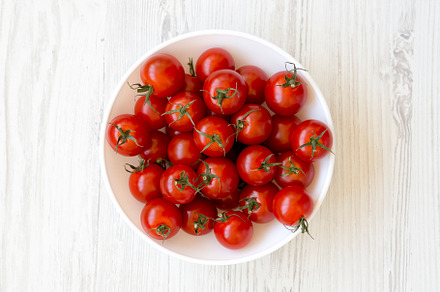 Fresh Red Organic Cherry Tomatoes in a Bowl, top view. Flat lay,, a Food & Drink Photo by LiudmylaChuhunova