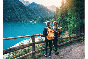 Two women with backpacks standing, a Nature Photo by den-belitsky