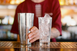 Preparing cocktail barkeeper counter shaker glass, a Food & Drink Photo by Photo Drive Studio
