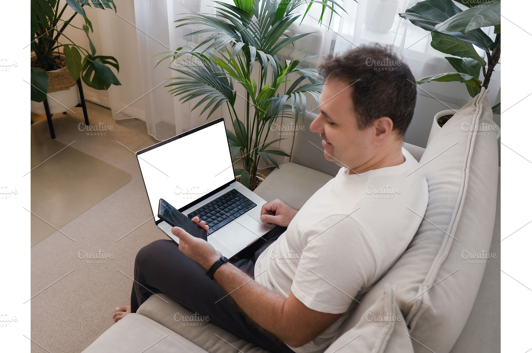 Man enjoying smartphone while laptop, a Person Photo by Fascinadora