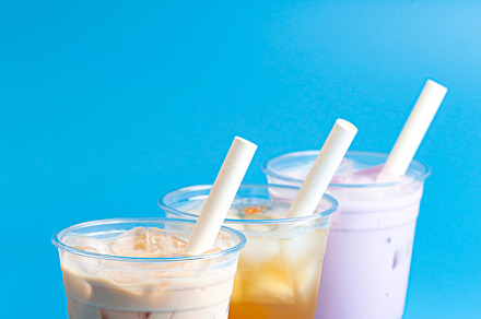 Three Different Types of Boba Tea on a Bright Blue Background