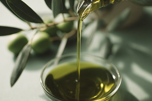 Pouring fresh extra virgin olive oil into a bowl, showcasing hea, a Photo by Studio ANNA