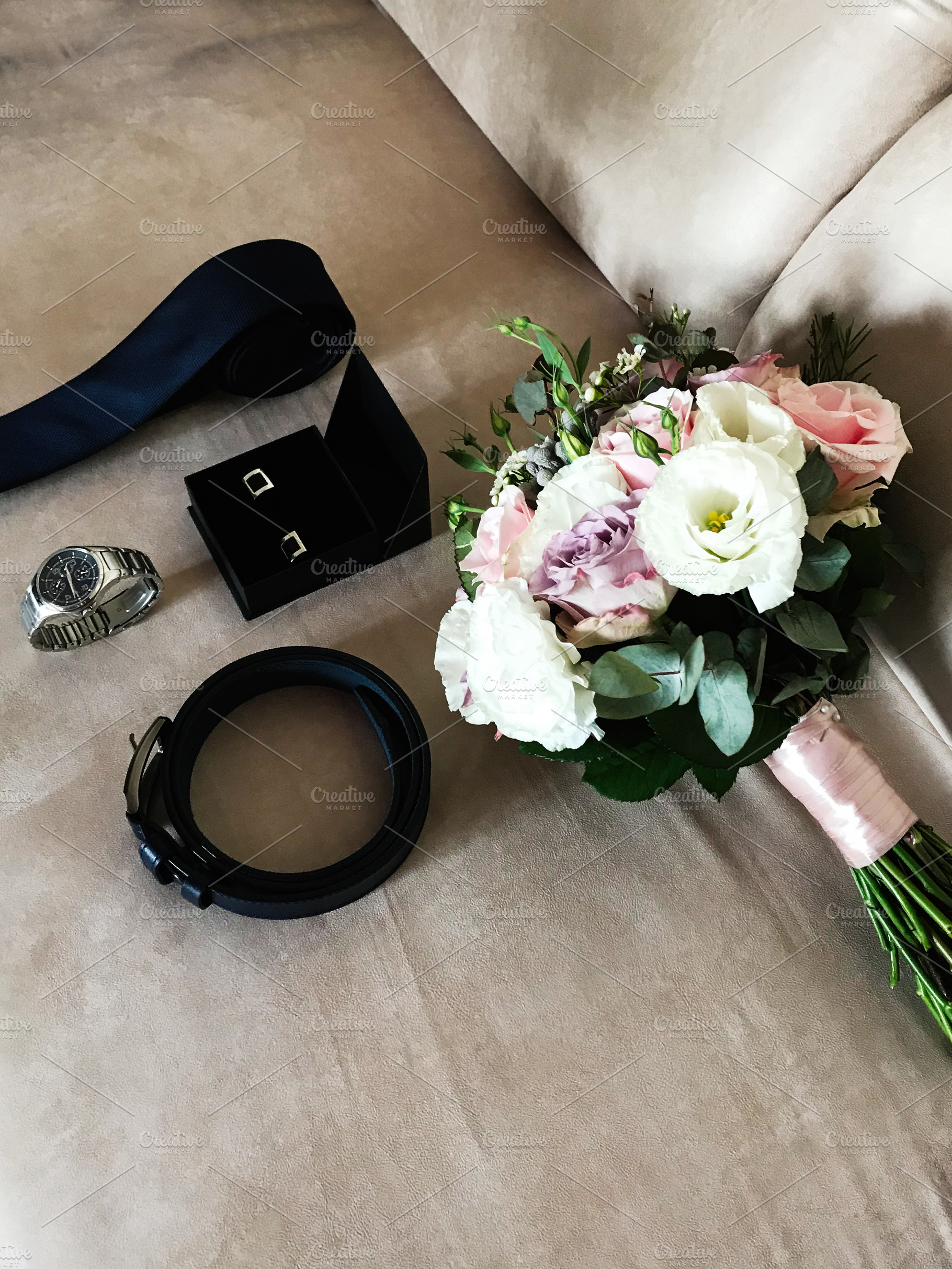 Elegant wedding accessories with bouquet, tie, belt, and watch, a Photo by AS photostudio
