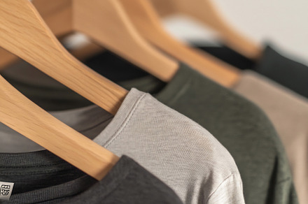 T-shirts on a wooden rack, a Photo by Beautiful things