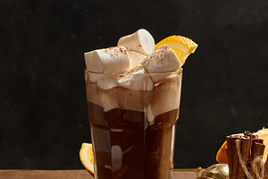 A glass of hot chocolate with white marshmallow pieces on a wood, a Food & Drink Photo by ndanko