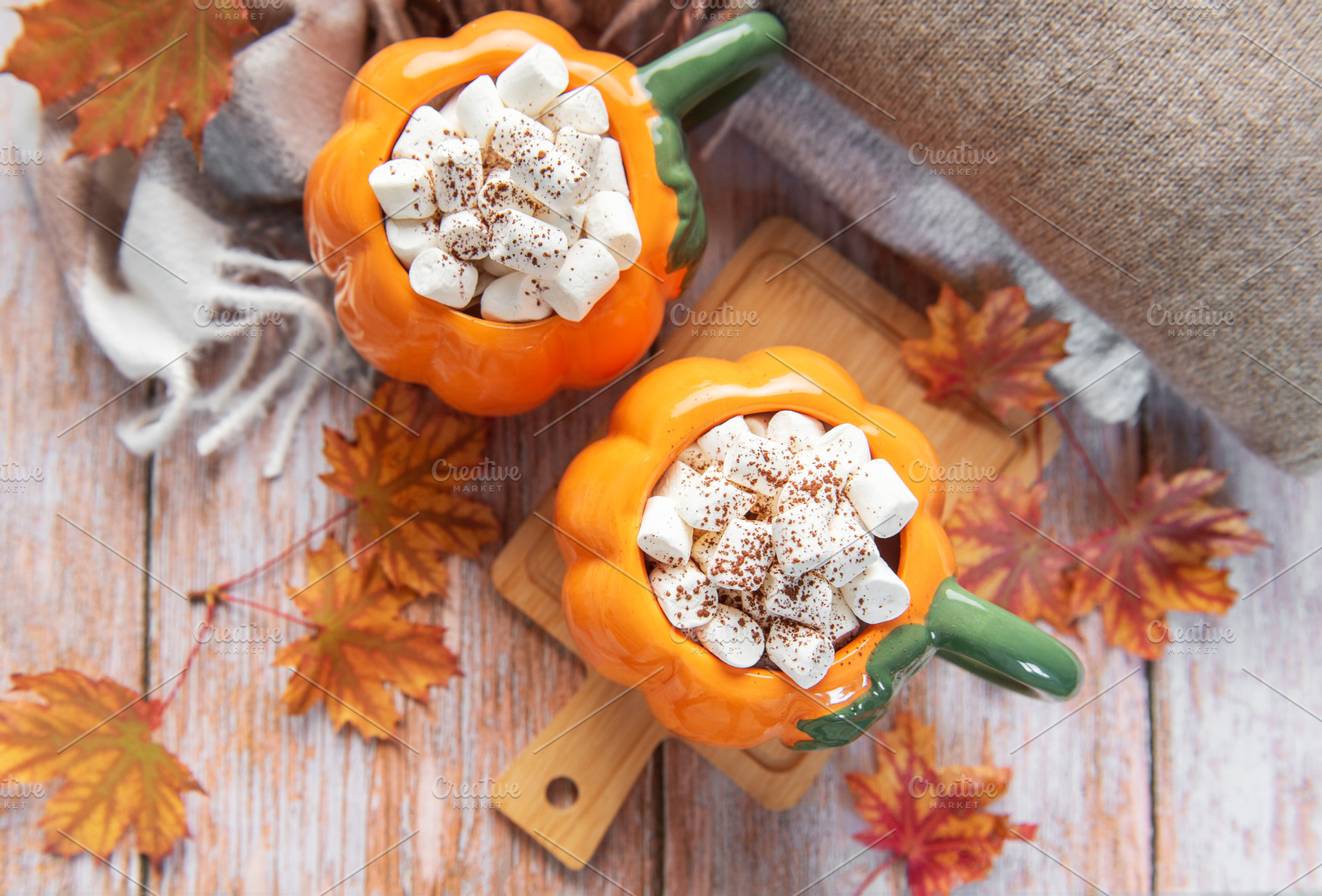 Pumpkin mugs filled with hot chocolate warming up for fall, a Food & Drink Photo by Olena Rudo