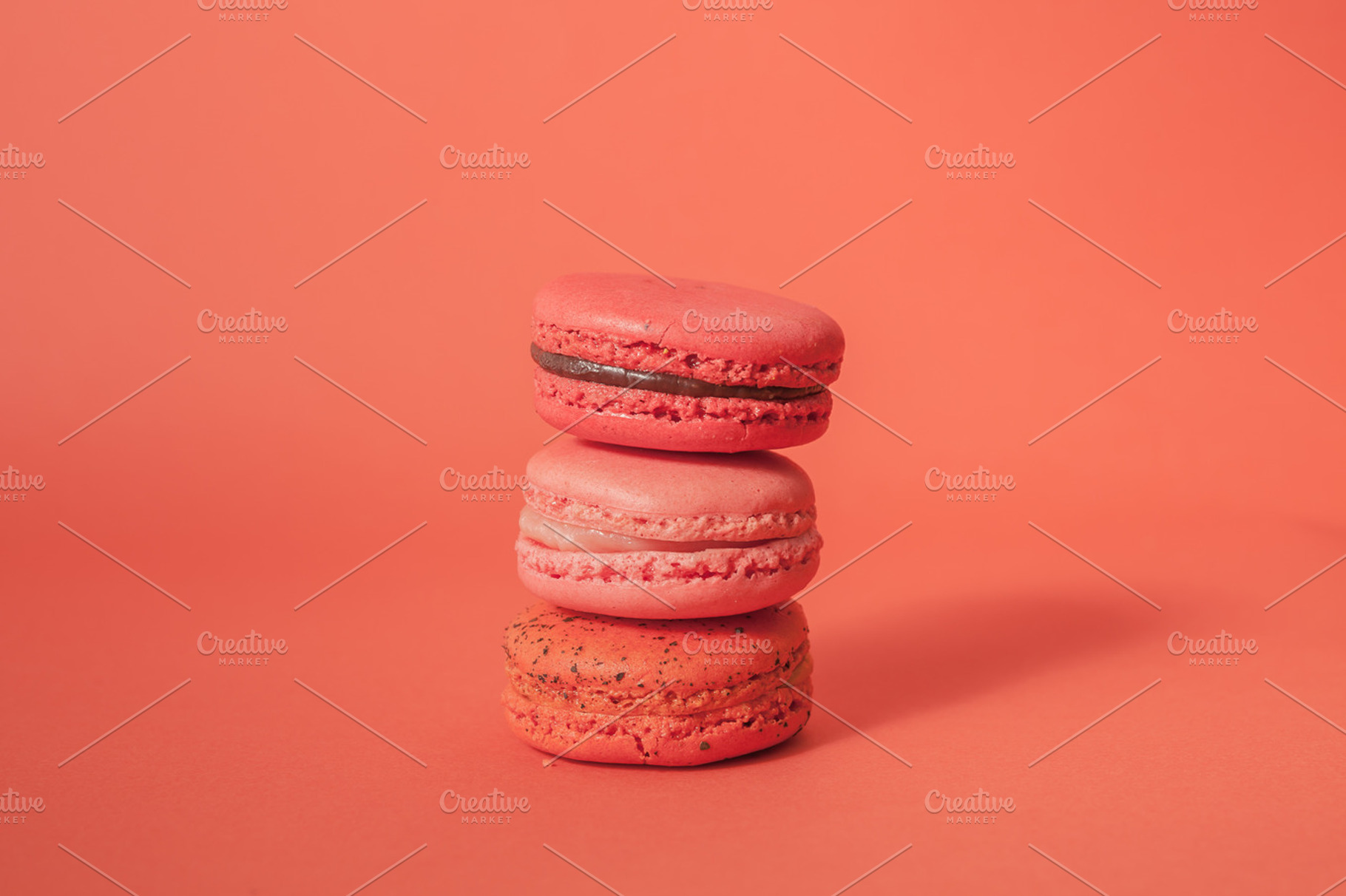 Stack of macaroons in red background, a Food & Drink Photo by Twinster Photo