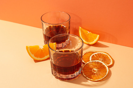 Concept of delicious alcohol drink, Whiskey with orange, a Food & Drink Photo by AtlasStudio PRO