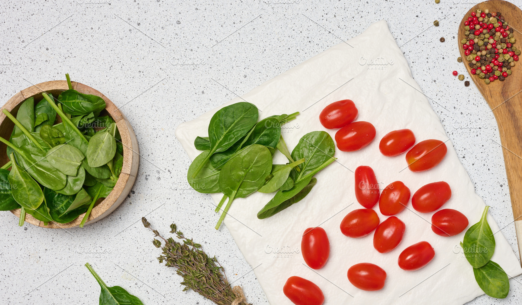 Wooden bowl with spinach, cherry tomatoes, wooden spoon with spi, a Food & Drink Photo by ndanko