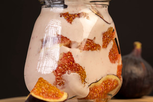 glass jar with fresh yogurt with ripe fresh figs, a Photo by rsoollAI