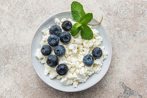 Cottage cheese bowl with fresh blueberries and mint, a Food & Drink Photo by Olena Rudo