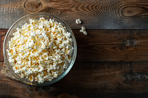 Popcorn on wood color background.Food and snack concepts ideas.Minimal style to, a Food & Drink Photo by Budarinphoto