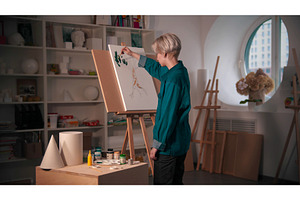 A young woman artist coloring her