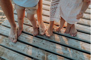 Legs and feet of family standing on, a Person Photo by HalfPoint
