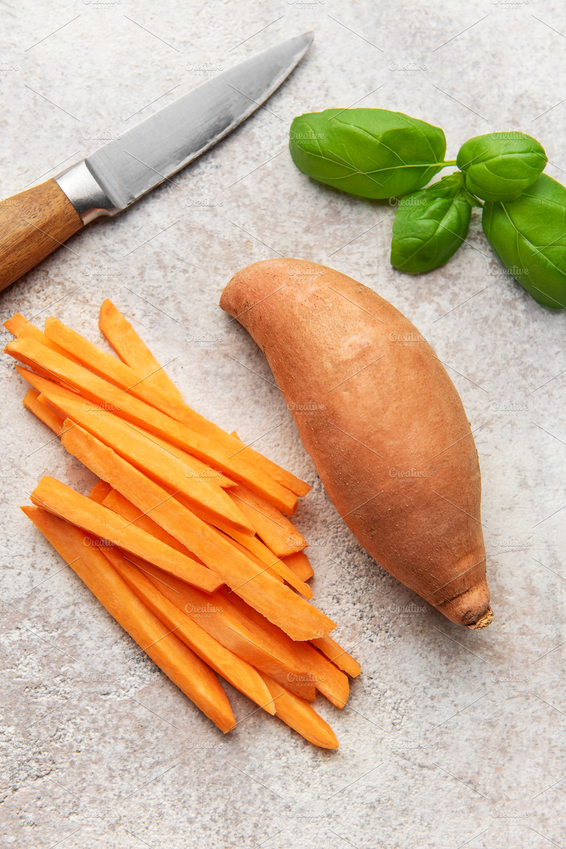 Preparing raw sweet potatoes for healthy fries with basil, a Food & Drink Photo by Olena Rudo