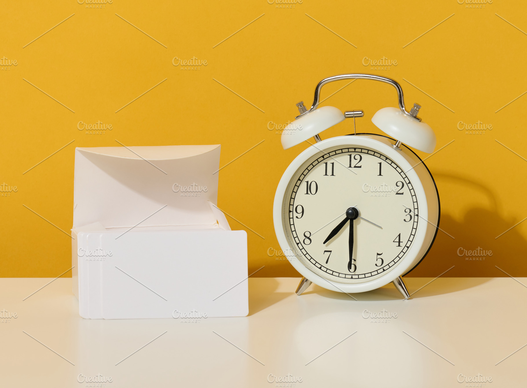 stack of white rectangular business cards on a yellow background, a Business Photo by ndanko