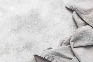 Gray kitchen textile on textured grunge counter background, a Food & Drink Photo by Olena Rudo