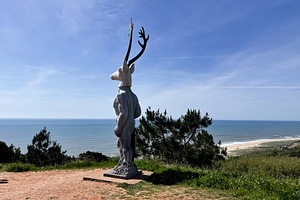 Sculpture of a mythical creature overlooking the sea in Nazare, Portugal, a Photo by AS photostudio