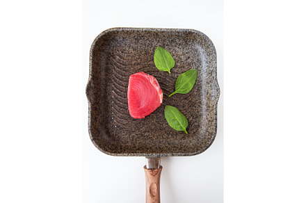 Fresh pink tuna lies on a grill pan, a Food & Drink Photo by Artsaba Family