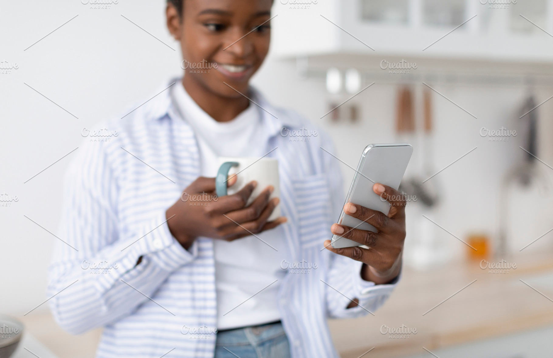 Smiling millennial african american female drink cup of coffee chatting on phon, a Person Photo by Prostock-Studio