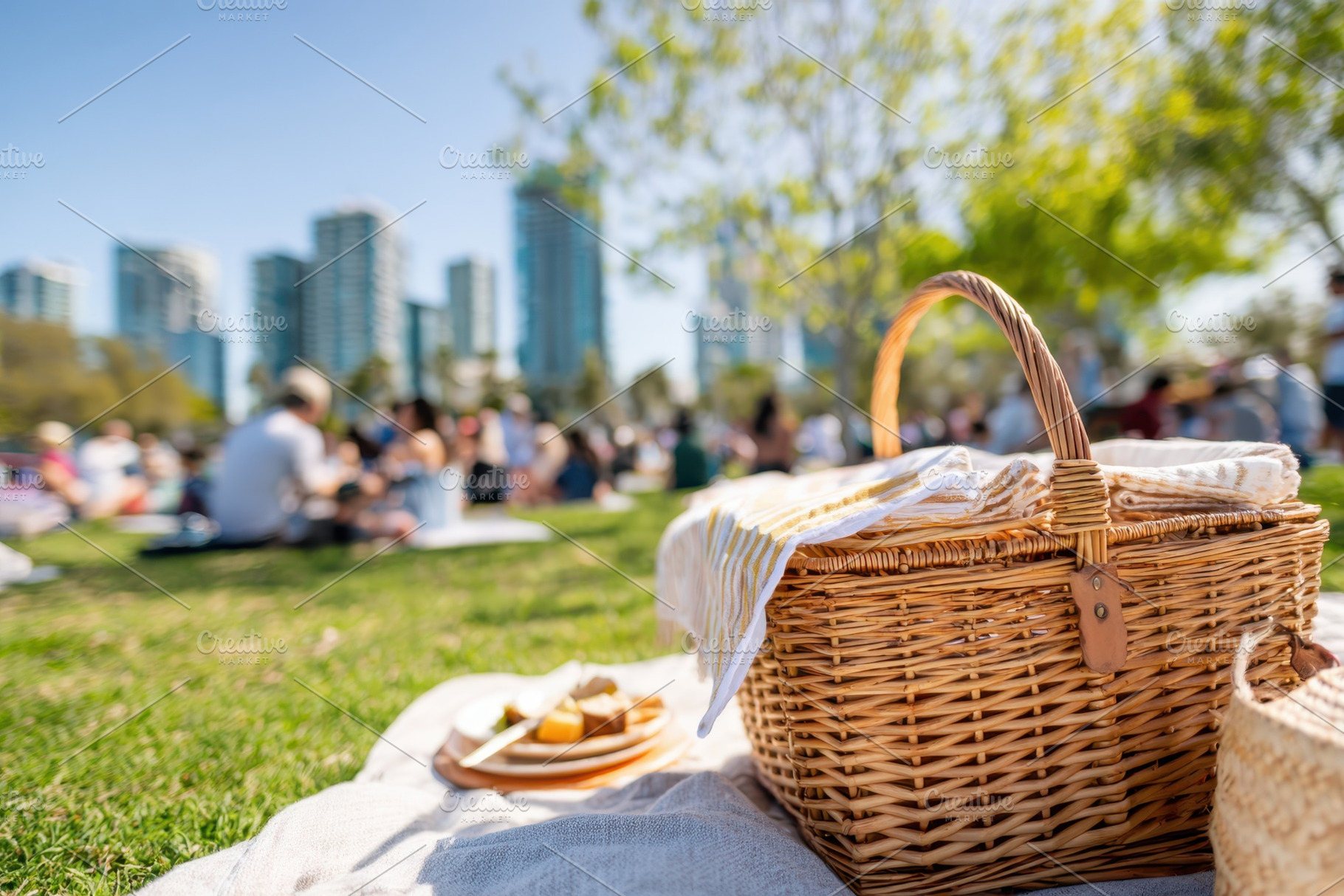 Wicker picnic basket in city park, a Food & Drink Photo by AlyaAnd