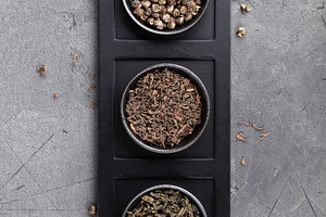 Assorted Loose Tea Leaves in Bowls on Dark Stone Background, a Food & Drink Photo by Natalia Klenova's Shop
