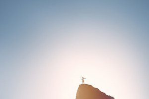 Happy girl on top of mountain