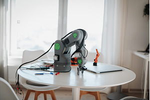 Robotic arm prototype on a table in, a Technology Photo by HalfPoint