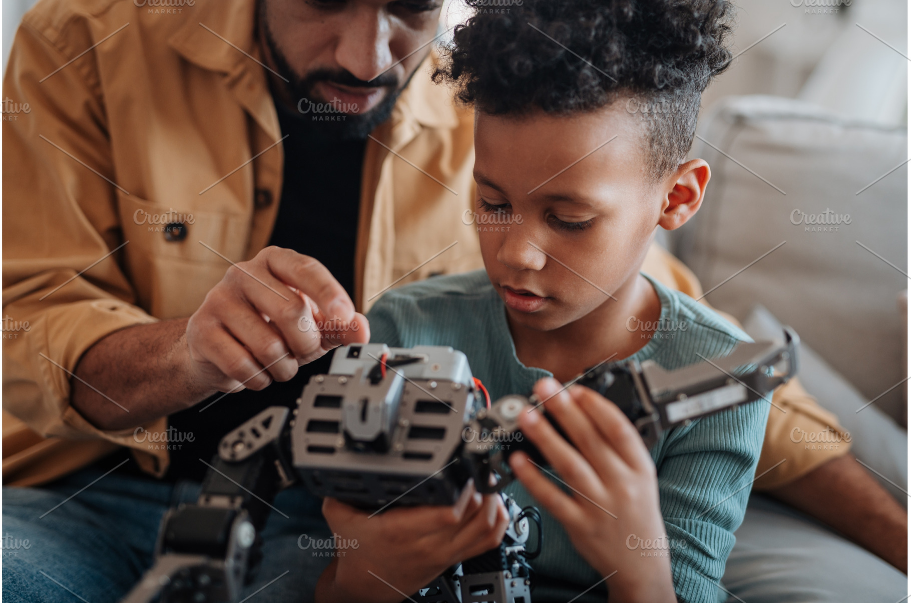 Father and son exploring STEM, a Technology Photo by HalfPoint